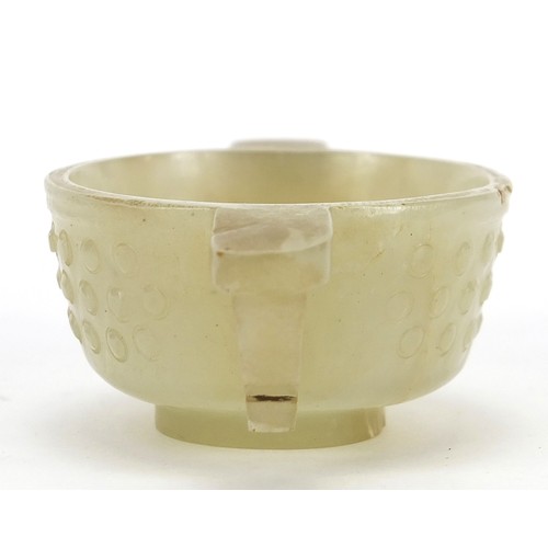 111 - Good Chinese carved celadon jade libation cup with twin handles, 9cm wide