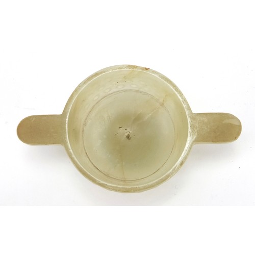 111 - Good Chinese carved celadon jade libation cup with twin handles, 9cm wide