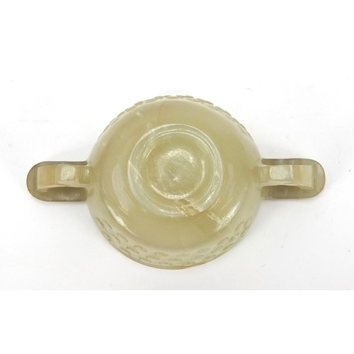 111 - Good Chinese carved celadon jade libation cup with twin handles, 9cm wide