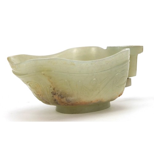 112 - Chinese celadon jade libation cup carved with water dragons, 10.5cm in length