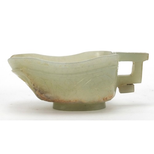 112 - Chinese celadon jade libation cup carved with water dragons, 10.5cm in length