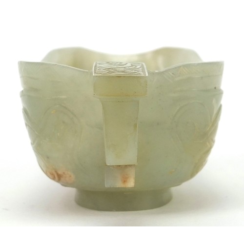 112 - Chinese celadon jade libation cup carved with water dragons, 10.5cm in length