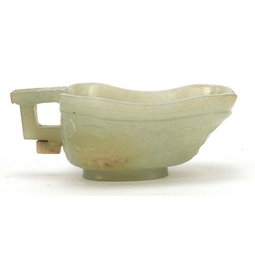 112 - Chinese celadon jade libation cup carved with water dragons, 10.5cm in length