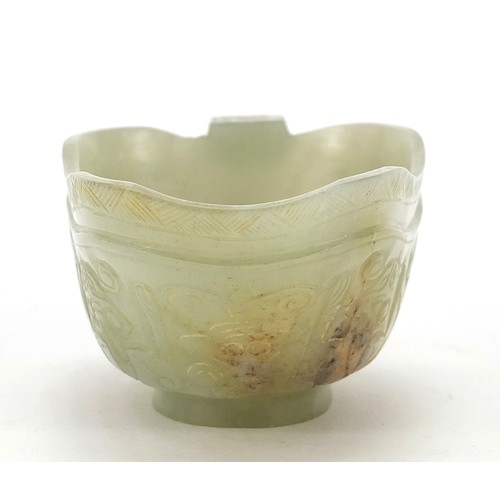 112 - Chinese celadon jade libation cup carved with water dragons, 10.5cm in length