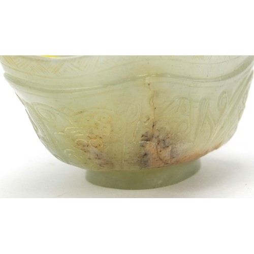 112 - Chinese celadon jade libation cup carved with water dragons, 10.5cm in length