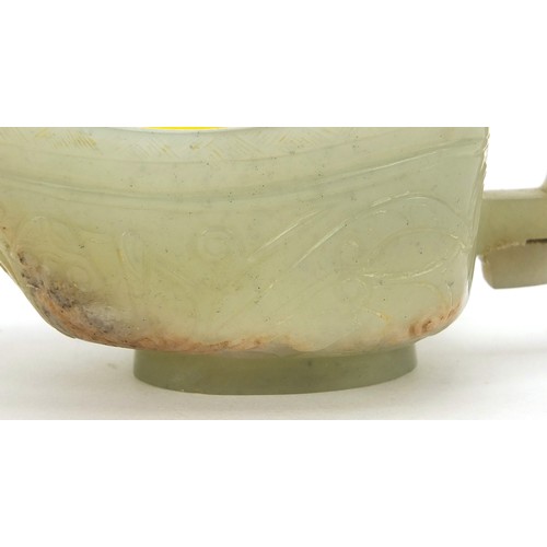 112 - Chinese celadon jade libation cup carved with water dragons, 10.5cm in length