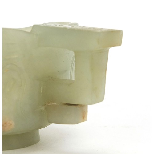 112 - Chinese celadon jade libation cup carved with water dragons, 10.5cm in length