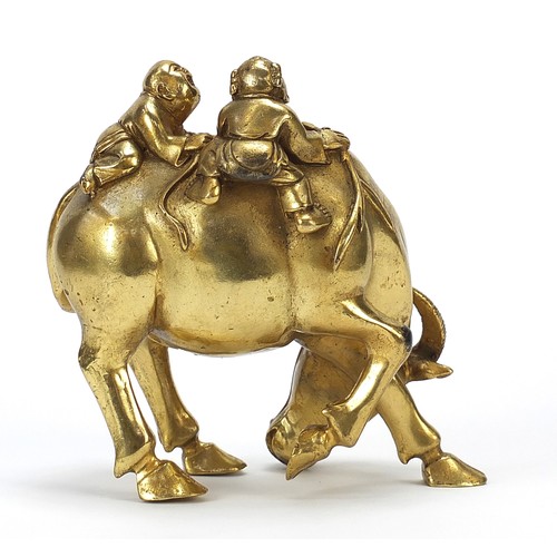 291 - Chinese gilt bronze figure of two boys on a water buffalo, 14cm high