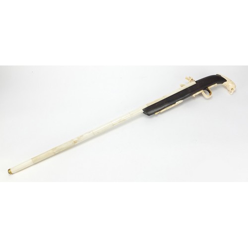 354 - Indian style hardwood and carved bone walking stick in the form of a rifle, 92cm in length