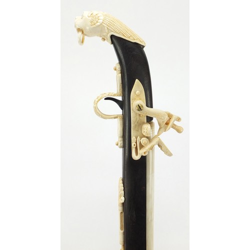 354 - Indian style hardwood and carved bone walking stick in the form of a rifle, 92cm in length