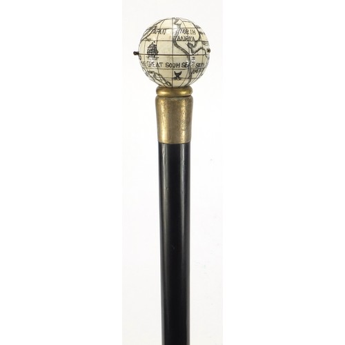 355 - Hardwood walking stick with carved bone globe and compass design pommel, 88cm in length