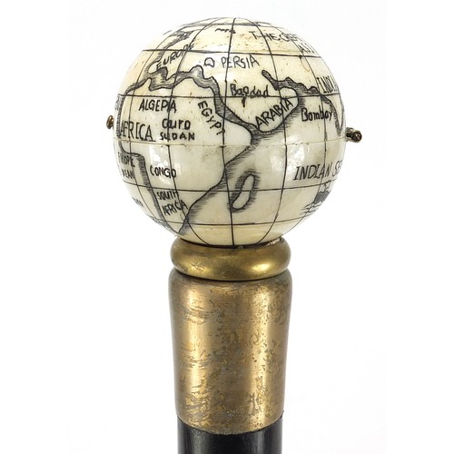 355 - Hardwood walking stick with carved bone globe and compass design pommel, 88cm in length