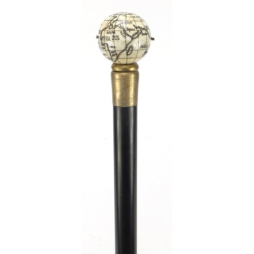 355 - Hardwood walking stick with carved bone globe and compass design pommel, 88cm in length