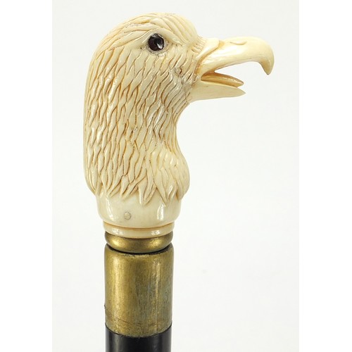 357 - Hardwood walking stick with carved bone bird head design pommel, 92cm in length