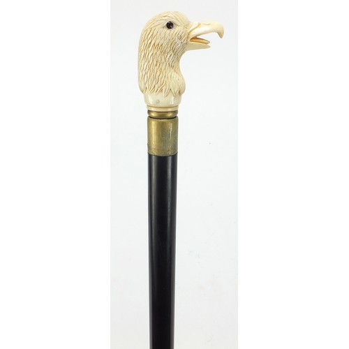 357 - Hardwood walking stick with carved bone bird head design pommel, 92cm in length