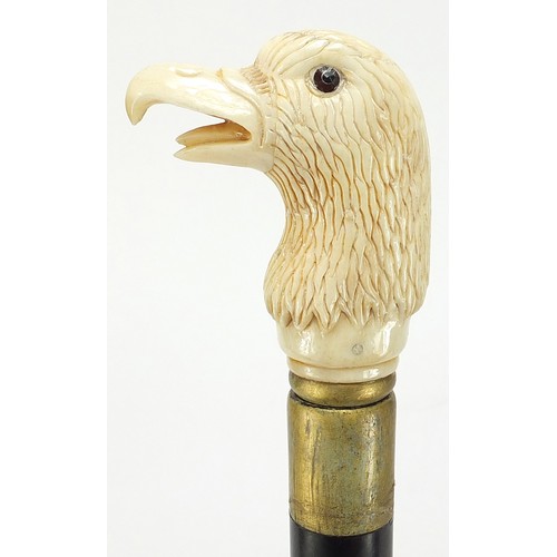 357 - Hardwood walking stick with carved bone bird head design pommel, 92cm in length