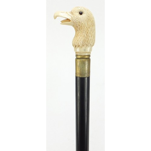 357 - Hardwood walking stick with carved bone bird head design pommel, 92cm in length