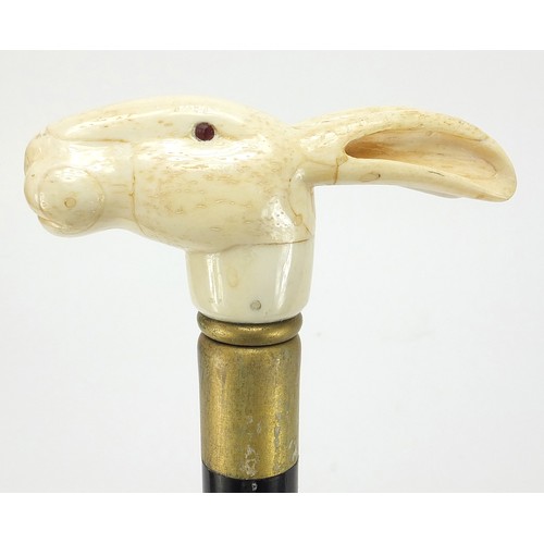 358 - Hardwood walking stick with carved bone hare head design pommel, 90cm in length