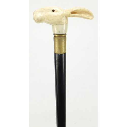 358 - Hardwood walking stick with carved bone hare head design pommel, 90cm in length