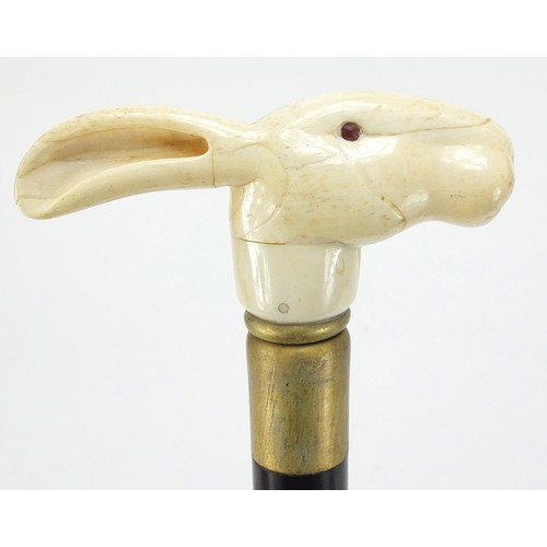 358 - Hardwood walking stick with carved bone hare head design pommel, 90cm in length