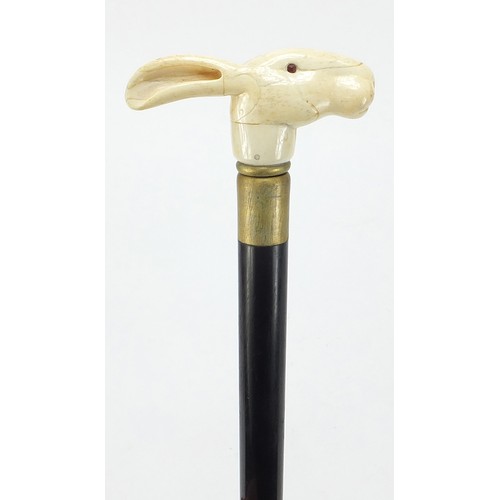 358 - Hardwood walking stick with carved bone hare head design pommel, 90cm in length