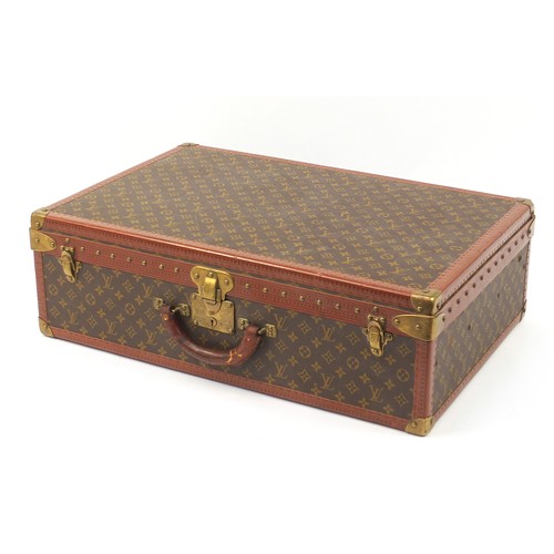 585 - Louis Vuitton, early 20th century suitcase with lift out tray, various impressed marks to the mounts... 