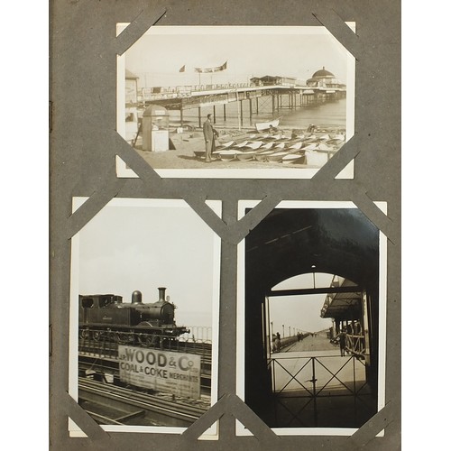 439 - Early 20th century postcards arranged in an album, predominantly photographic including railway loco... 