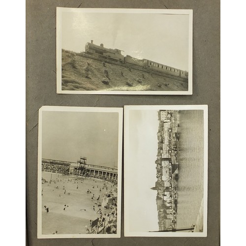 439 - Early 20th century postcards arranged in an album, predominantly photographic including railway loco... 