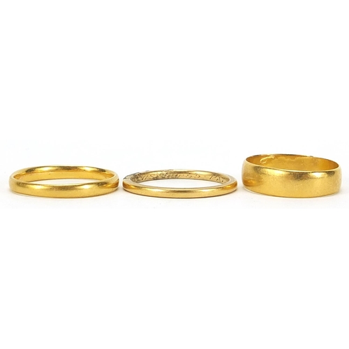 695 - Three 22ct gold wedding bands, Birmingham 1915 size O, London 1933 size T and one with indistinct ha... 