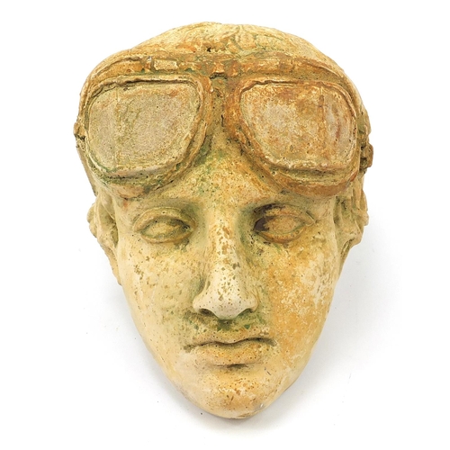 2590 - Military interest garden stoneware wall mask of a pilot, 26cm high