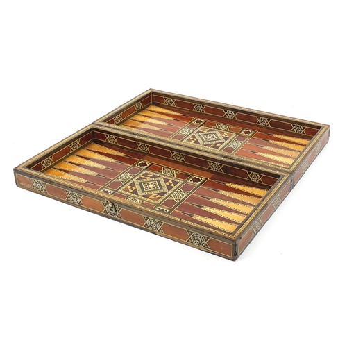 931 - Syrian Moorish design inlaid folding games/chess board with draught pieces, 49cm x 49cm when open