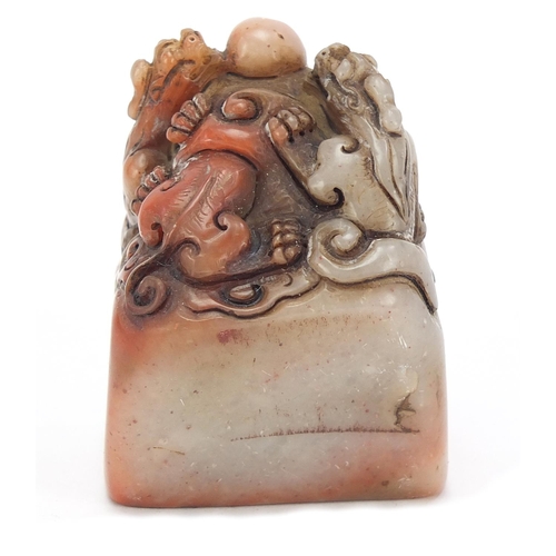 384 - Chinese soapstone seal carved with dragons, character marks to the base, 6.5cm high