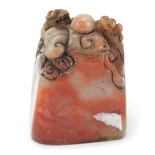 384 - Chinese soapstone seal carved with dragons, character marks to the base, 6.5cm high