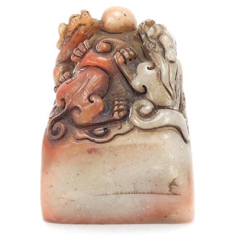 384 - Chinese soapstone seal carved with dragons, character marks to the base, 6.5cm high