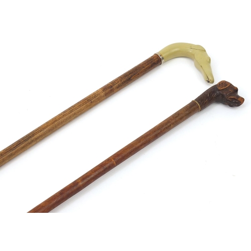 1939 - Two hardwood walking sticks with dog's head design handles including a carved wood example, the larg... 