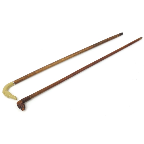 1939 - Two hardwood walking sticks with dog's head design handles including a carved wood example, the larg... 