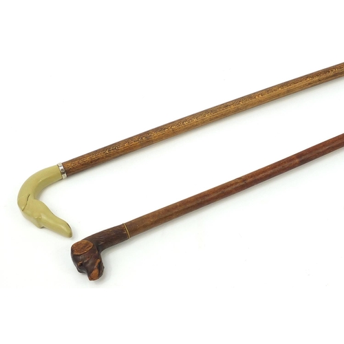 1939 - Two hardwood walking sticks with dog's head design handles including a carved wood example, the larg... 