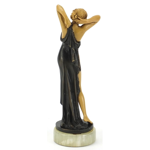 305 - Art Deco style bronzed and ivorine figurine of a scantily dressed female raised on a circular onyx b... 