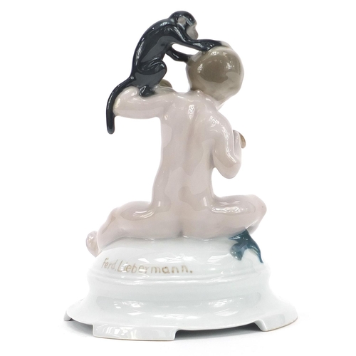 197 - Ferdinand Liebermann for Rosenthal, porcelain figure of a young boy feeding a monkey, 17cm high