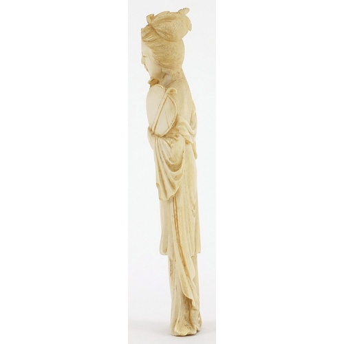 169 - Japanese carved ivory okimono of a young female holding a fan and flowers, 18cm high