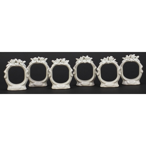 2037 - Set of six German floral encrusted napkin ring holders, each 5.5cm high