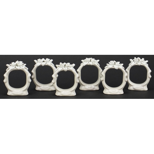 2037 - Set of six German floral encrusted napkin ring holders, each 5.5cm high