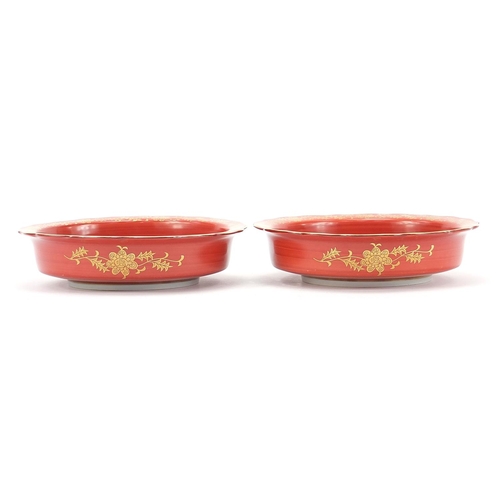 166 - Pair of Japanese iron red ground porcelain dishes hand painted and gilded with flowers, each with ch... 