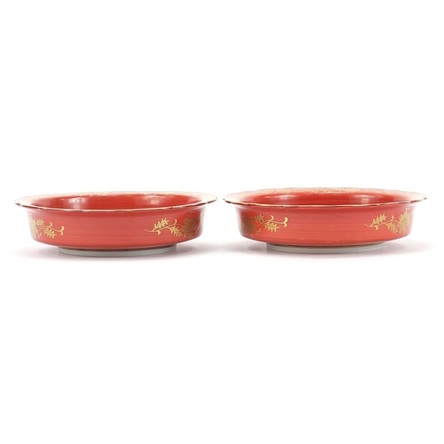 166 - Pair of Japanese iron red ground porcelain dishes hand painted and gilded with flowers, each with ch... 