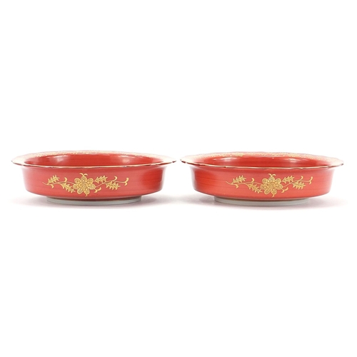 166 - Pair of Japanese iron red ground porcelain dishes hand painted and gilded with flowers, each with ch... 