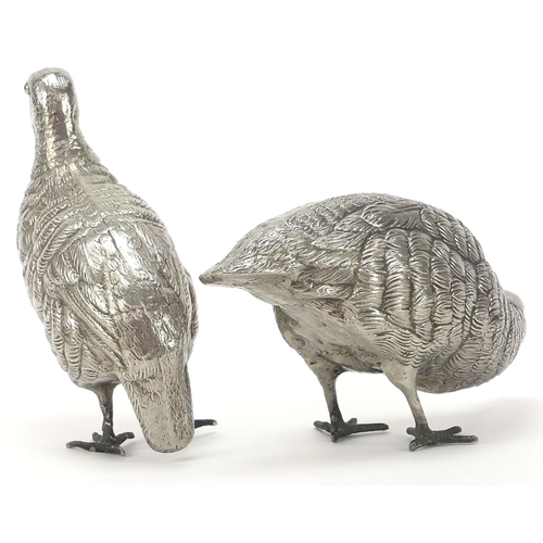 2080 - Pair of silver plated peahens, the largest 16.5cm high