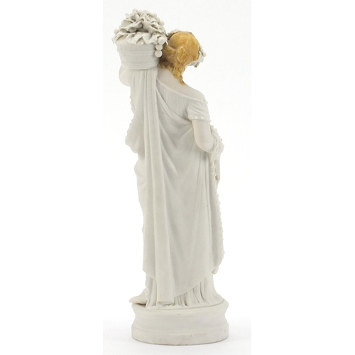 2050 - 19th century parian figurine of a maiden holding a basket, 34cm high