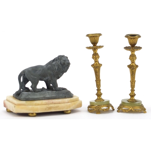 1959 - Pair of gilt metal and onyx figural candlesticks and sculpture of a lion, the largest each 17cm high