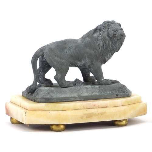 1959 - Pair of gilt metal and onyx figural candlesticks and sculpture of a lion, the largest each 17cm high