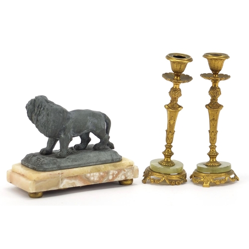 1959 - Pair of gilt metal and onyx figural candlesticks and sculpture of a lion, the largest each 17cm high